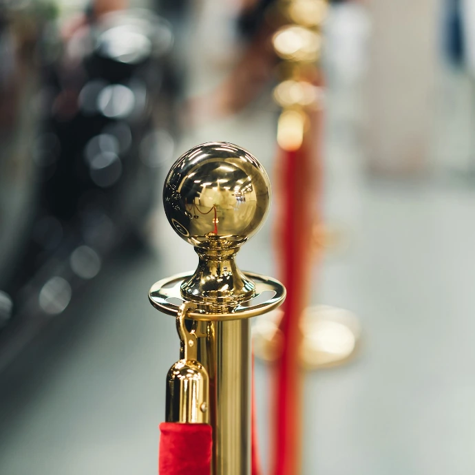 a row of red and gold poles with a golden ball on top